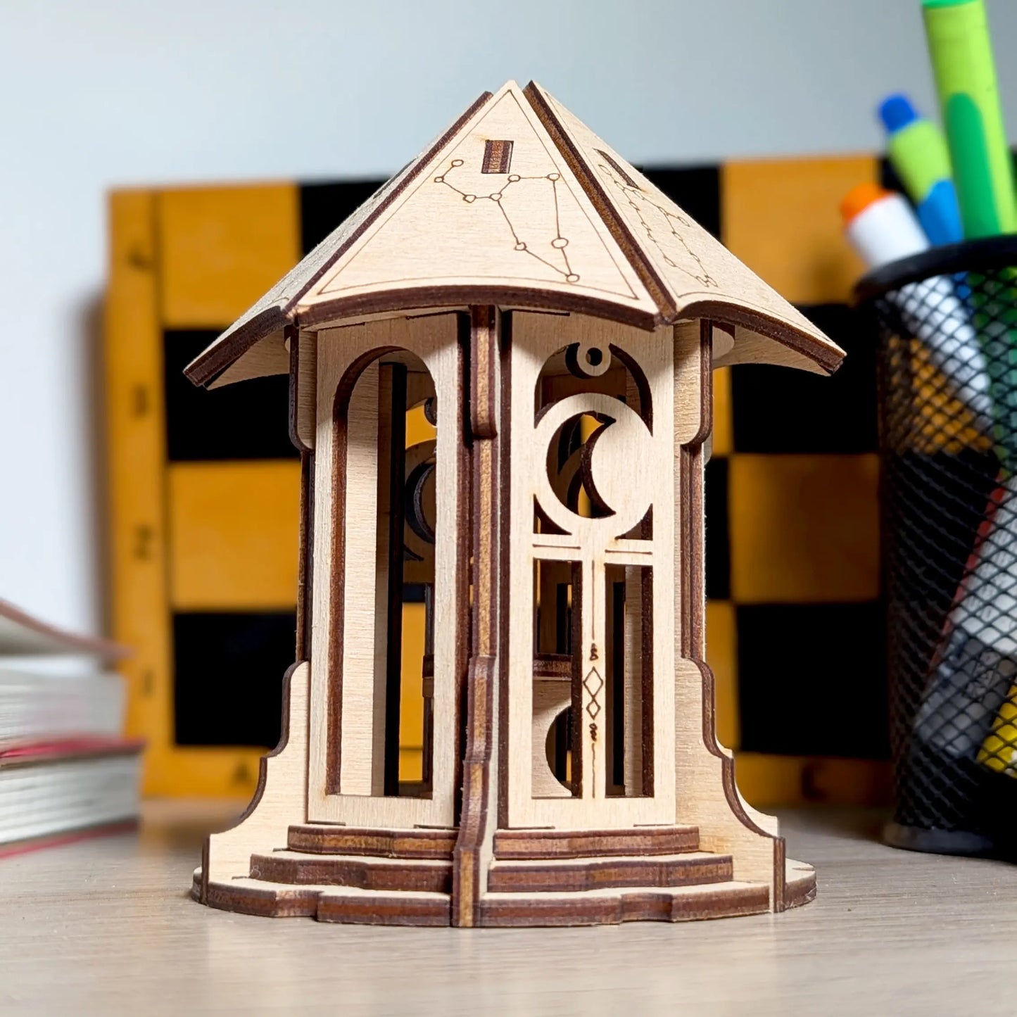 Detailed close-up showing the intricate star engraving and cutouts on the roof of a laser cut plywood astronomical gazebo.