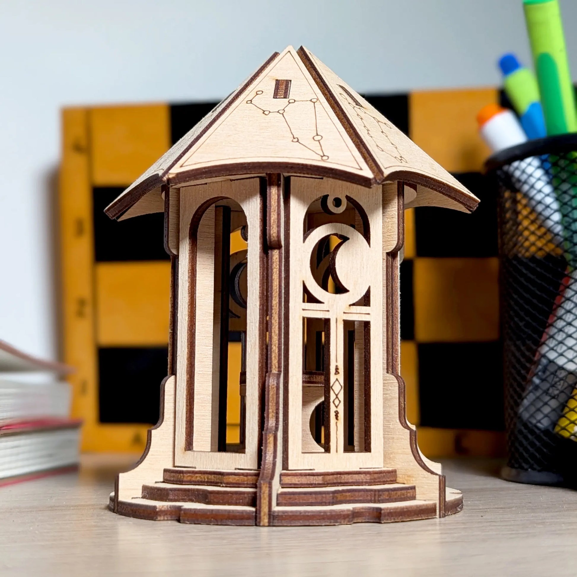 Detailed close-up showing the intricate star engraving and cutouts on the roof of a laser cut plywood astronomical gazebo.