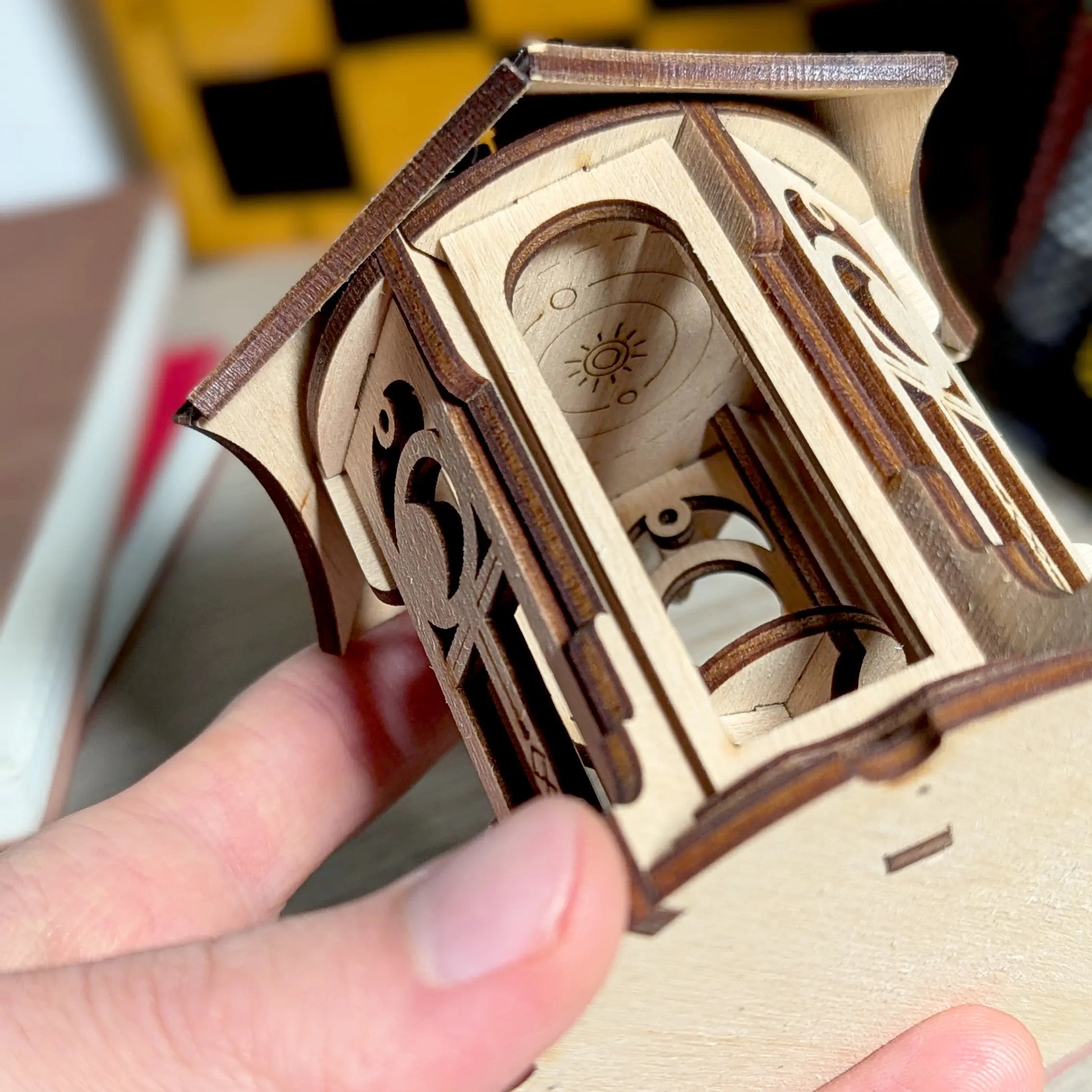 Detailed side view close-up focusing on the ornate stairs and arched entrance of a laser cut plywood astronomical gazebo.