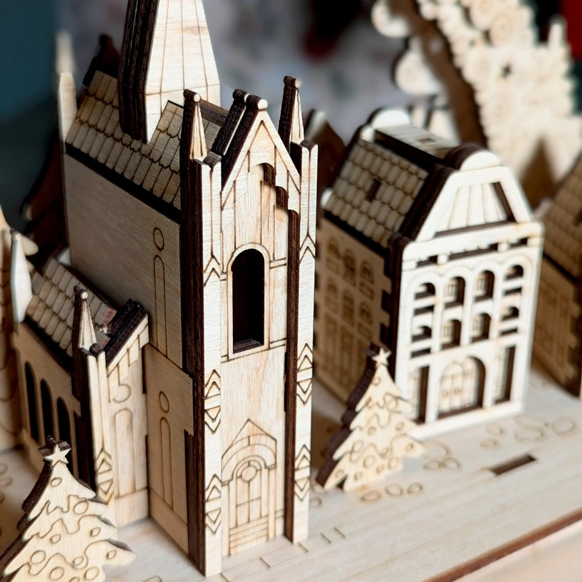 Detailed macro close-up photo focusing on the central miniature Gothic cathedral tower constructed of laser cut plywood