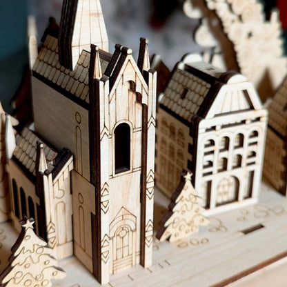 Detailed macro close-up photo focusing on the central miniature Gothic cathedral tower constructed of laser cut plywood