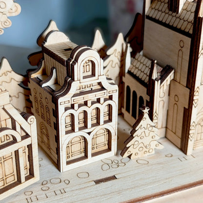 Detailed macro close-up photo focusing on an intricate miniature holiday village house assembled from laser cut plywood.