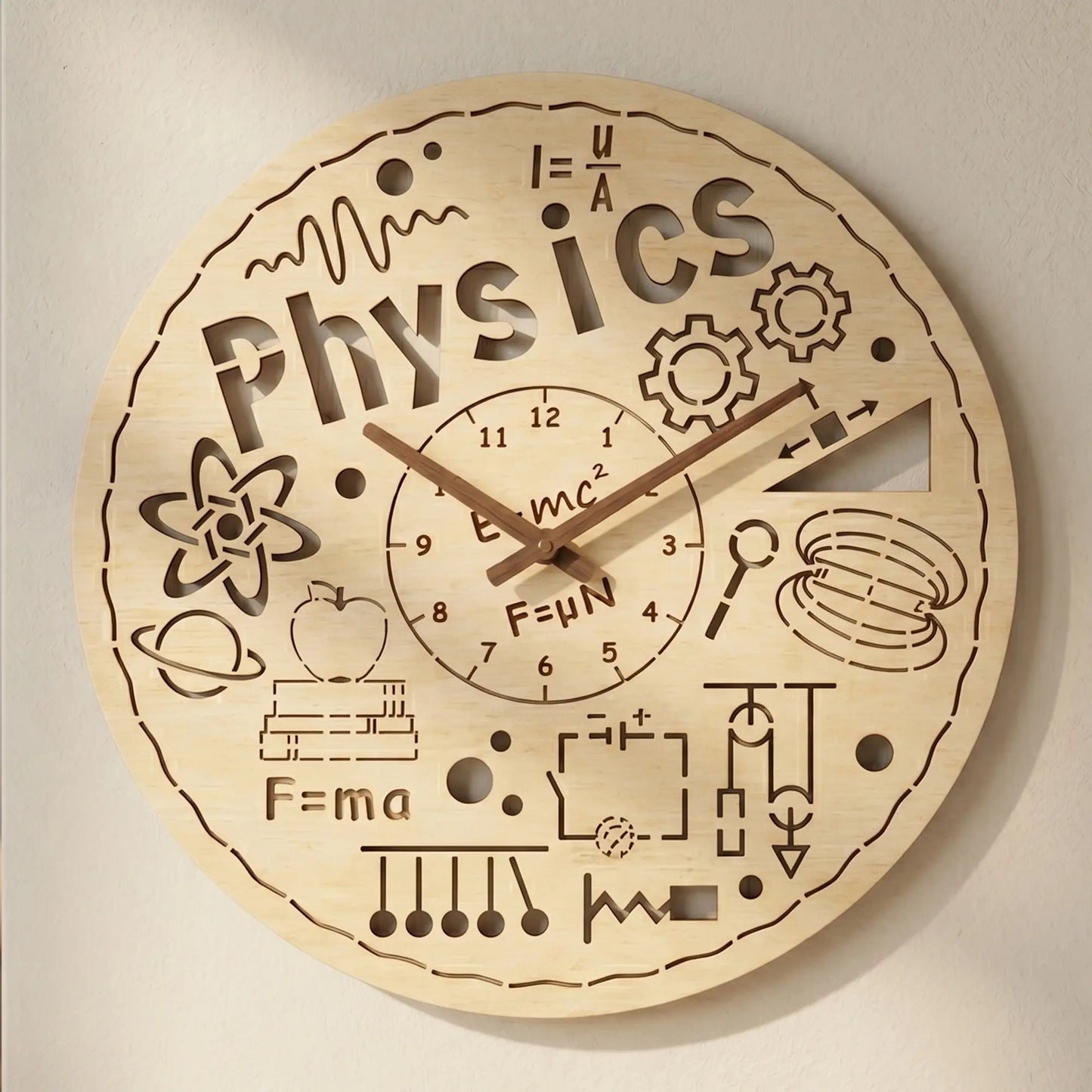 Detailed laser cut plywood wall clock with 'Physics' text, E=mc^2 formula, atom and gear icons, and dark wooden clock hands.