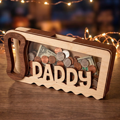 Laser cut plywood handsaw shaped bank with Daddy sign and acrylic window filled with coins and cash on a bokeh background.