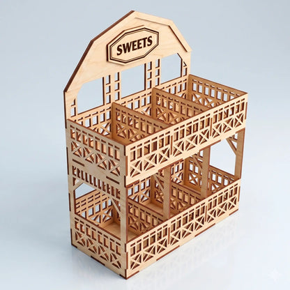 Laser cut plywood two tier barn display stand with Sweets sign, empty compartments and carved fences on white background