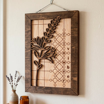Laser cut plywood framed wall sign showing a 3D layered flower branch and engraved flower vibe words on a grid backdrop.