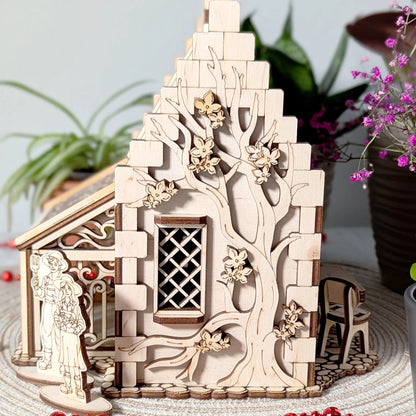 A side angle shot of a laser cut plywood garden cottage showcasing a large intricately engraved blooming tree on the wall.