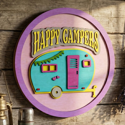 Layered circular laser cut plywood Happy Campers sign with a colorful retro trailer on a rustic wall in farmhouse style