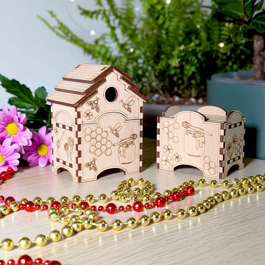 Compact laser cut plywood beehive box next to a small matching box holder styled with gold and red bead garlands.