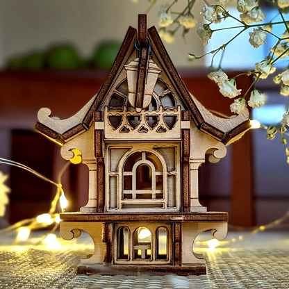 Front-facing view of a laser cut plywood fairy house, showcasing architectural windows and decorative wood balcony.