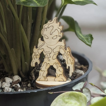 Staged in a plant pot, this laser cut plywood lava elemental figurine features dripping magma details and a flaming head