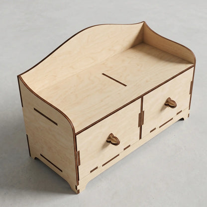 High-angle view of an empty tabletop organizer with drawers made of laser cut plywood, on a neutral gray surface