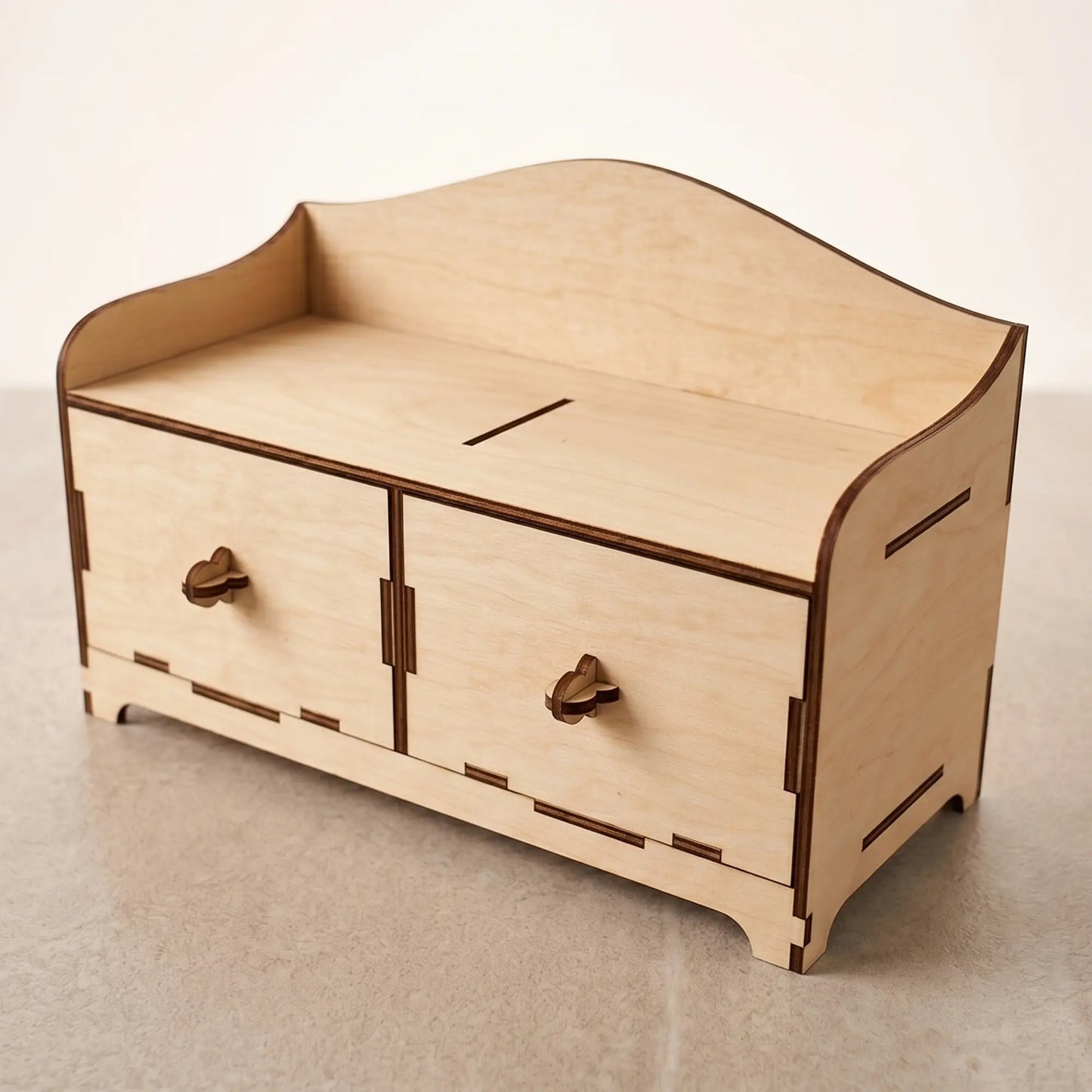 Empty wooden desktop mini-chest with two drawers, crafted from laser cut plywood and staged on a light background.