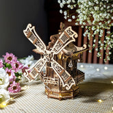 Stunning three-quarter view of a vintage 3D miniature windmill with warm glowing lights, made from layered laser cut plywood.