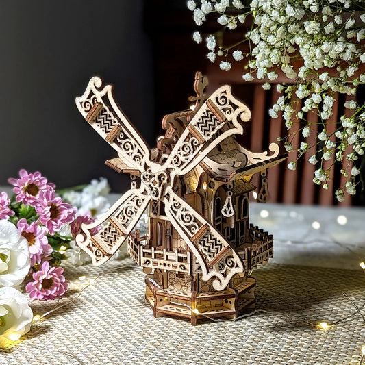 Stunning three-quarter view of a vintage 3D miniature windmill with warm glowing lights, made from layered laser cut plywood.
