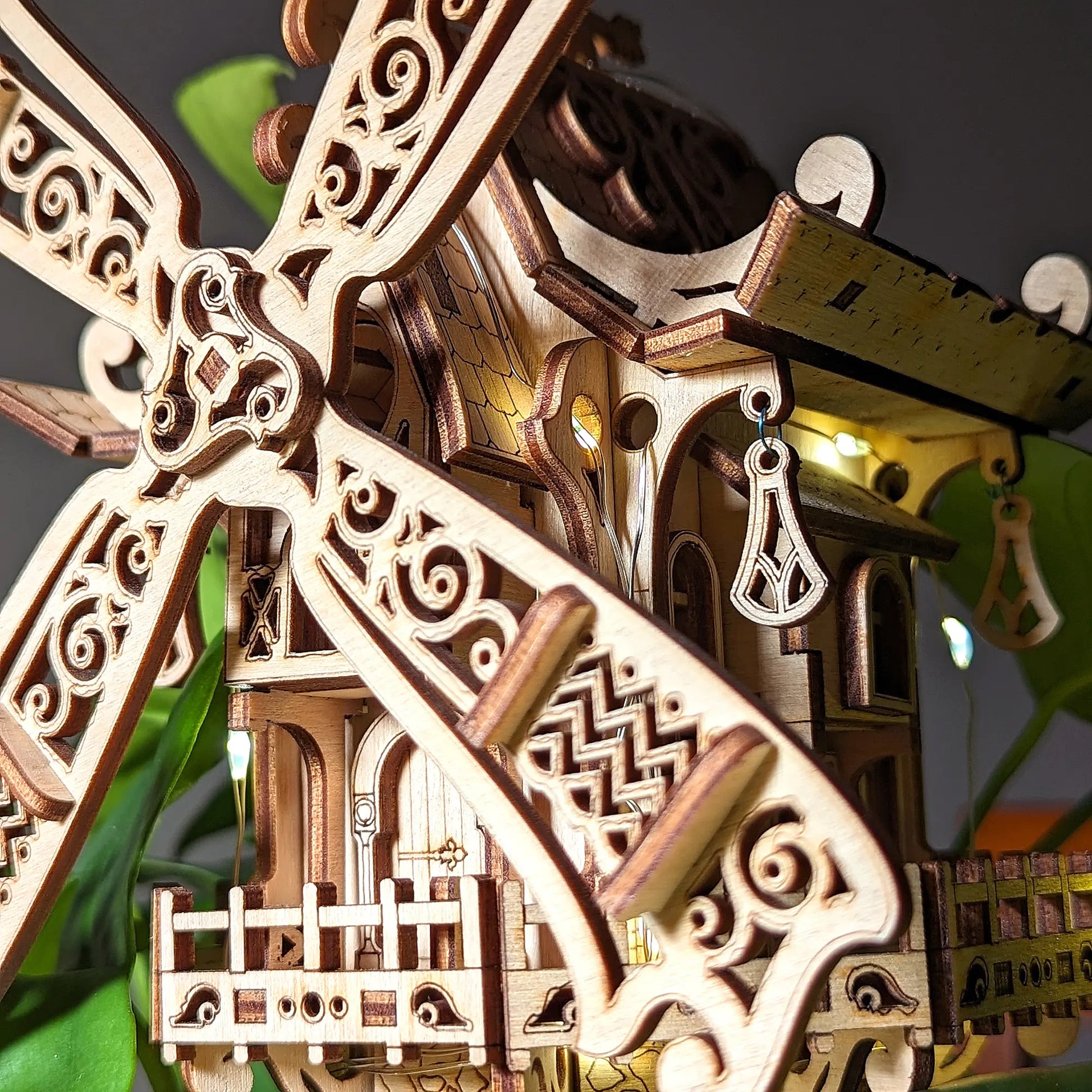 Detailed macro close-up view of a decorative 3D windmill sail featuring delicate charms made from fine laser cut plywood.