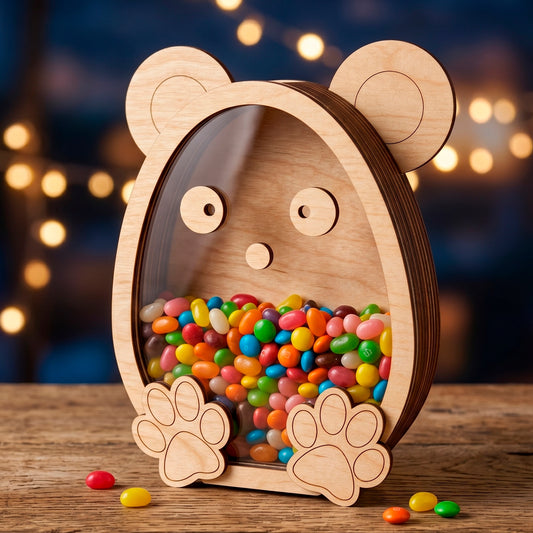 Laser cut plywood bear shaped candy box with a clear acrylic window filled with jelly beans on a blurry bokeh background.