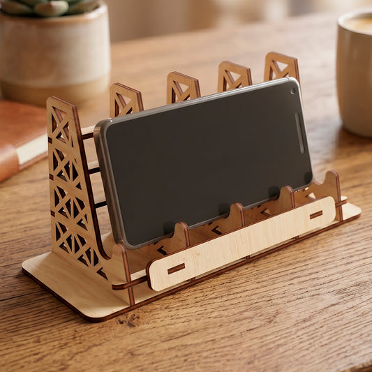 Laser cut plywood multi slot phone holder stand with a smartphone, featuring geometric truss design on a wooden table.
