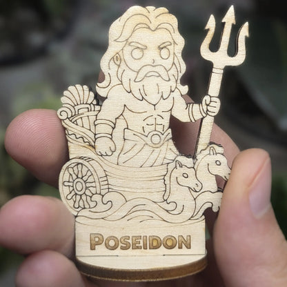 Hand holds a laser cut plywood Poseidon for scale. Shows the detailed trident, crown, and flowing beard at tiny scale