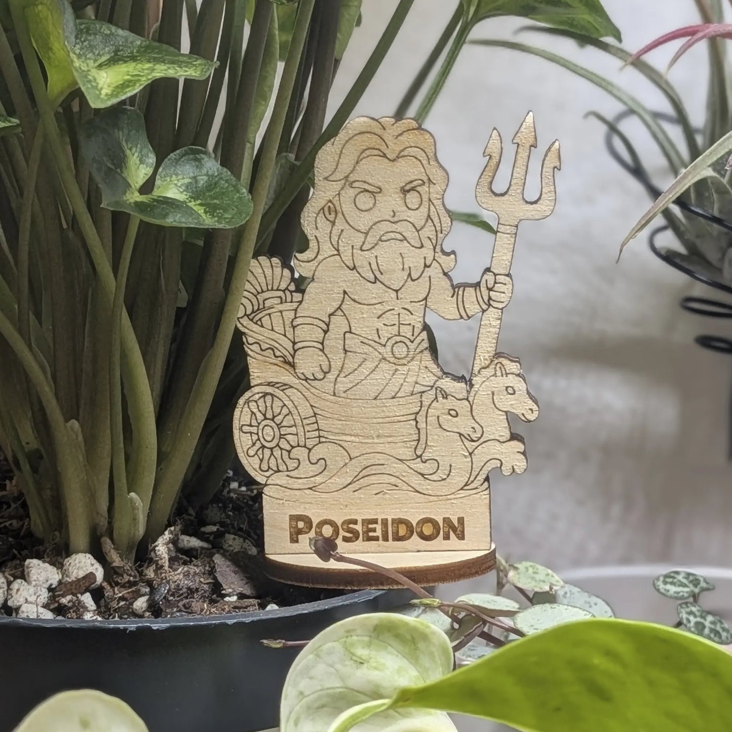 Laser cut plywood Poseidon figurine in a plant pot. Features a trident, crown, and detailed beard on a wood base