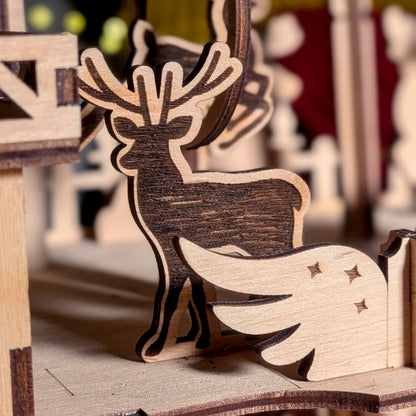Close-up of a wooden reindeer figure from a laser cut holiday scene, showing engraved texture and layered construction details
