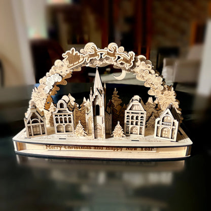 Centered front view photo of an assembled Christmas village arch display on a dark table, crafted using laser cut plywood.
