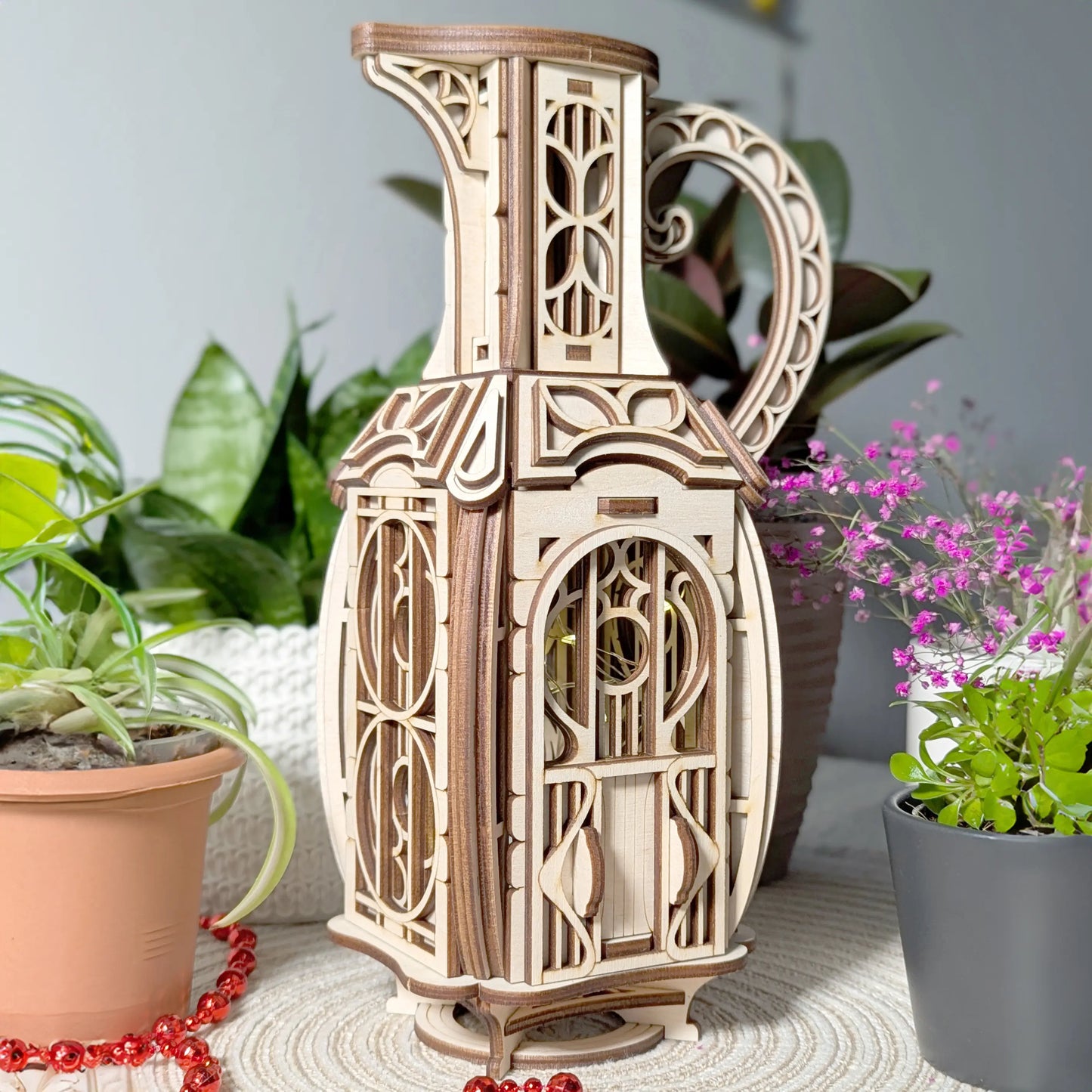 Detailed close-up shot showing the arched door and multi-layer wood textures of a laser cut plywood jug miniature house.