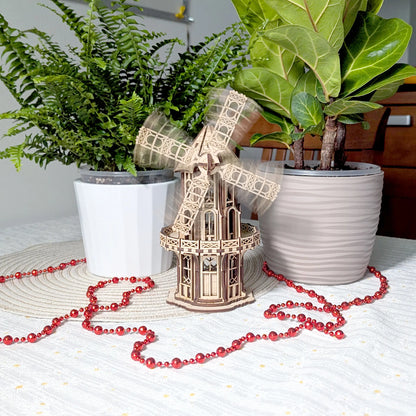 Action motion blur photo showing functional blades spinning on the finished laser cut plywood Victorian windmill model.