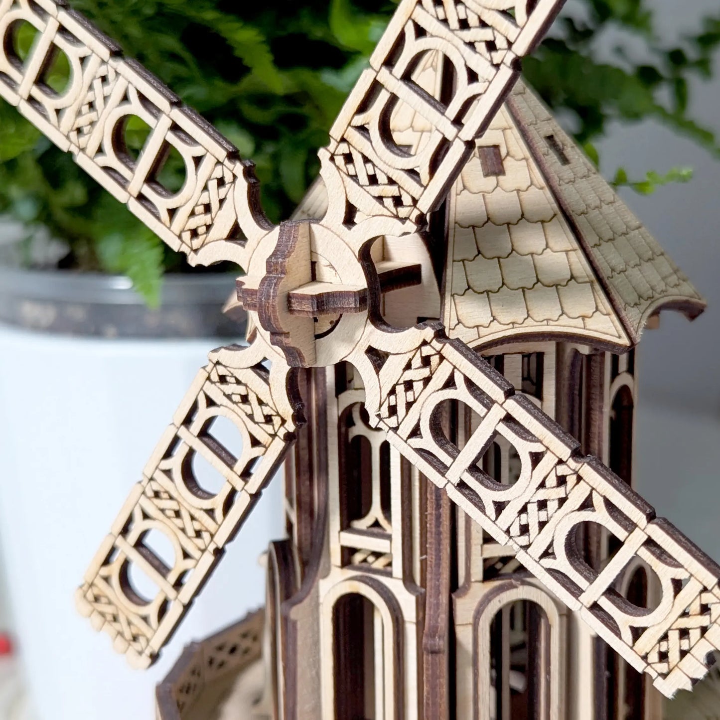 High-detail view of the laser cut plywood windmill rotor head, decorative blades, and finely engraved roof shingles.