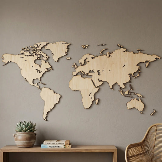 Minimalist laser cut plywood world map wall art above a shelf with a succulent and books in a modern, neutral living room.