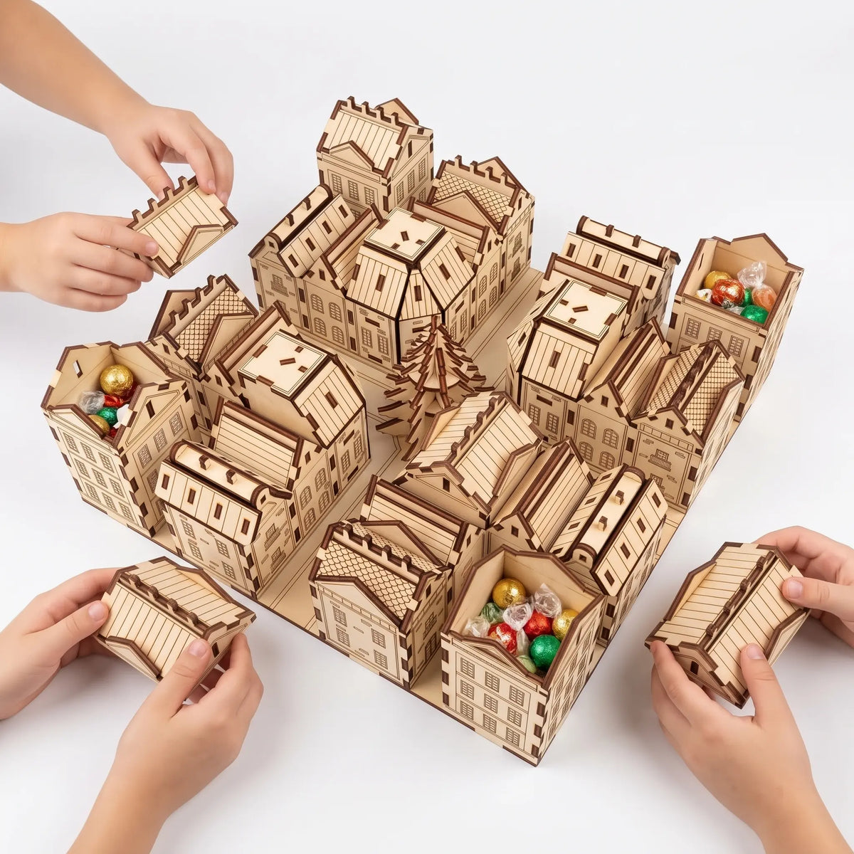 Children opening laser cut plywood advent calendar city boxes filled with wrapped sweets on a seamless white background.