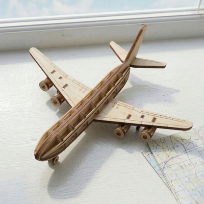 laser cut airplane model on a light surface with a map in the background