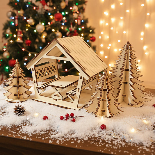 Laser cut wooden Alcove with Christmas trees featuring a cozy gazebo with lattice sides, picnic table and three detailed fir trees, displayed against a colorful Christmas tree lights bokeh background.