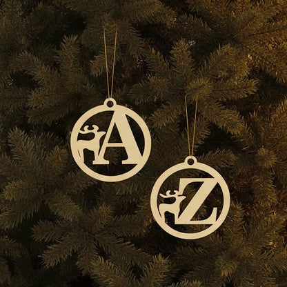 Personalized laser cut Alphabet for Christmas tree in elegant circle frames with integrated deer motifs and hanging loops, set against a festive lighted Christmas tree background.