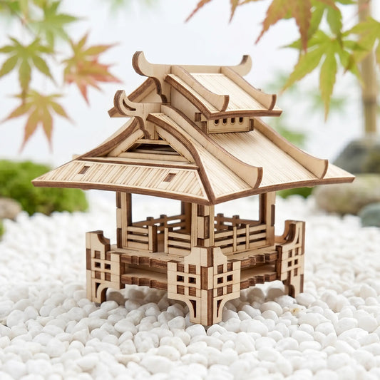 Wooden model of a traditional Japanese pagoda on pebbles with blurred leaves in the background