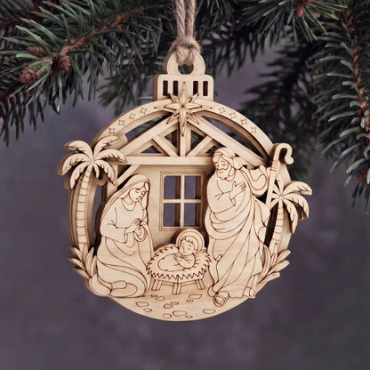Layered laser cut plywood Holy Family nativity ornament hanging with twine rope on evergreen Christmas tree boughs