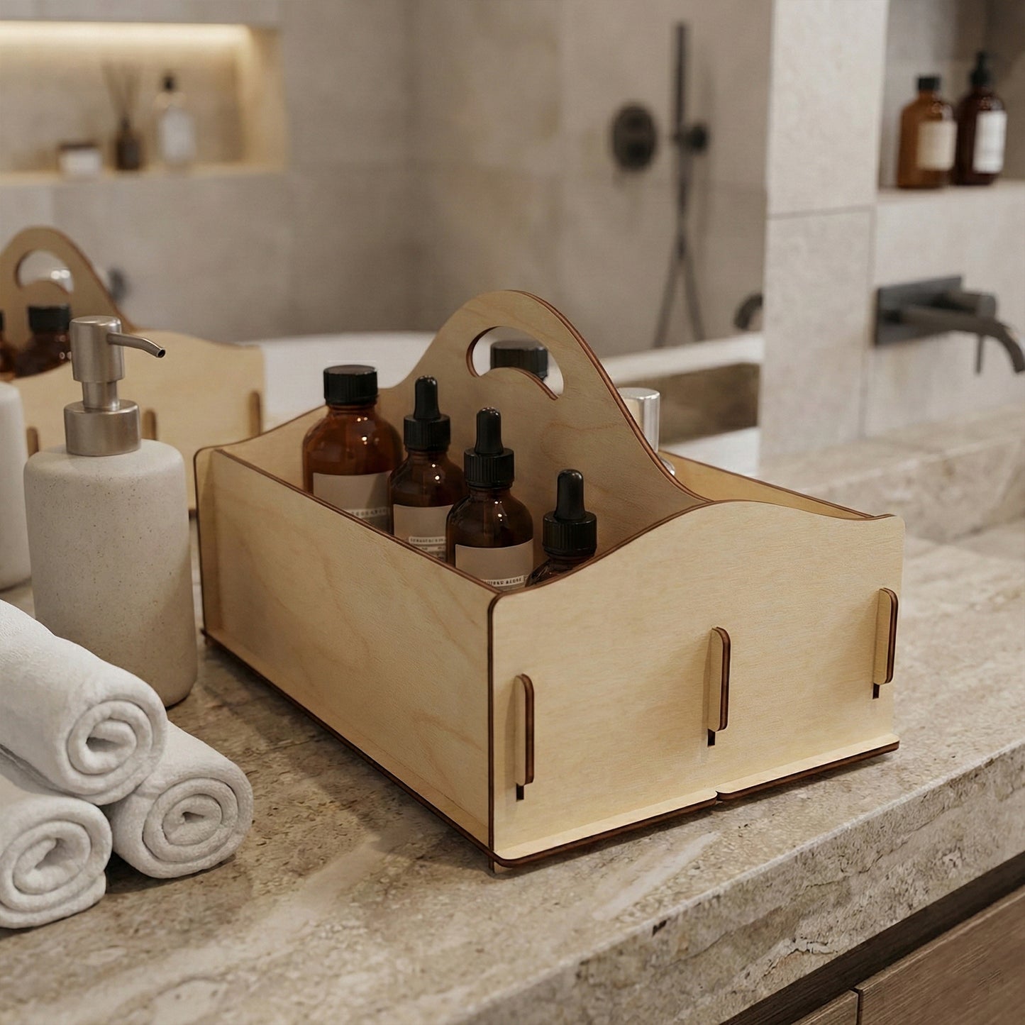 Laser cut plywood caddy used as a bathroom organizer on a marble countertop. The wooden box holds several brown glass apothecary bottles with droppers. White rolled towels and a soap dispenser are visible in the foreground