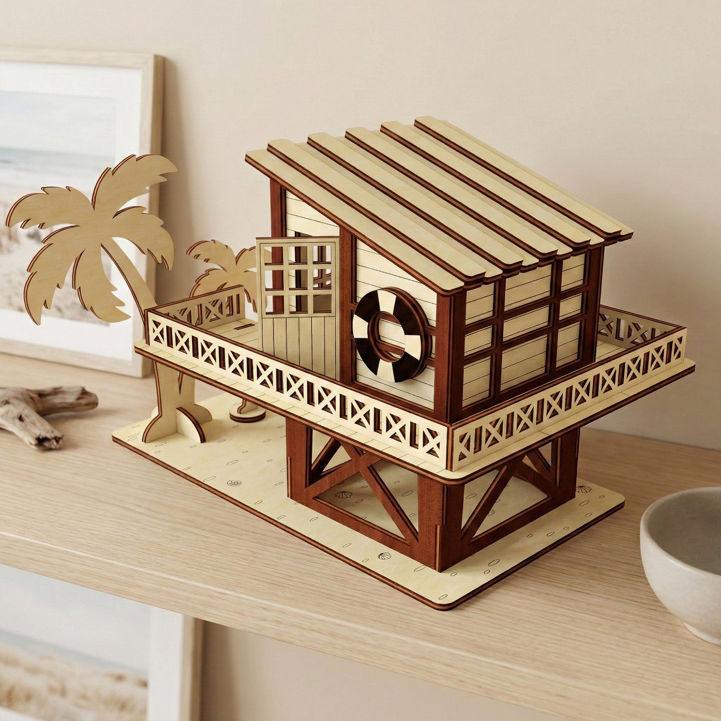 Back view of the laser cut plywood beach house, highlighting the slatted roof design and two vertical surfboards leaning against the wall. The tiered balcony railing shows intricate geometric cutouts