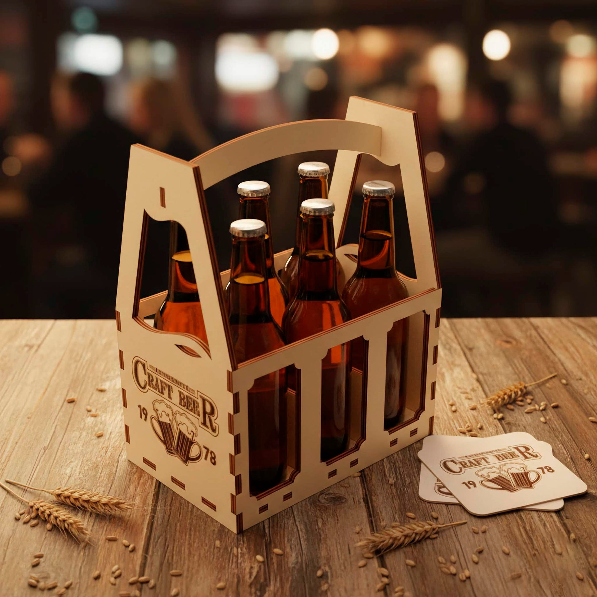 High-angle view of a 6-pack beer carrier made from laser cut plywood. The design shows precise finger-joint construction and decorative side cutouts. Scattered wheat stalks and engraved wooden coasters surround the caddy on a wood surface