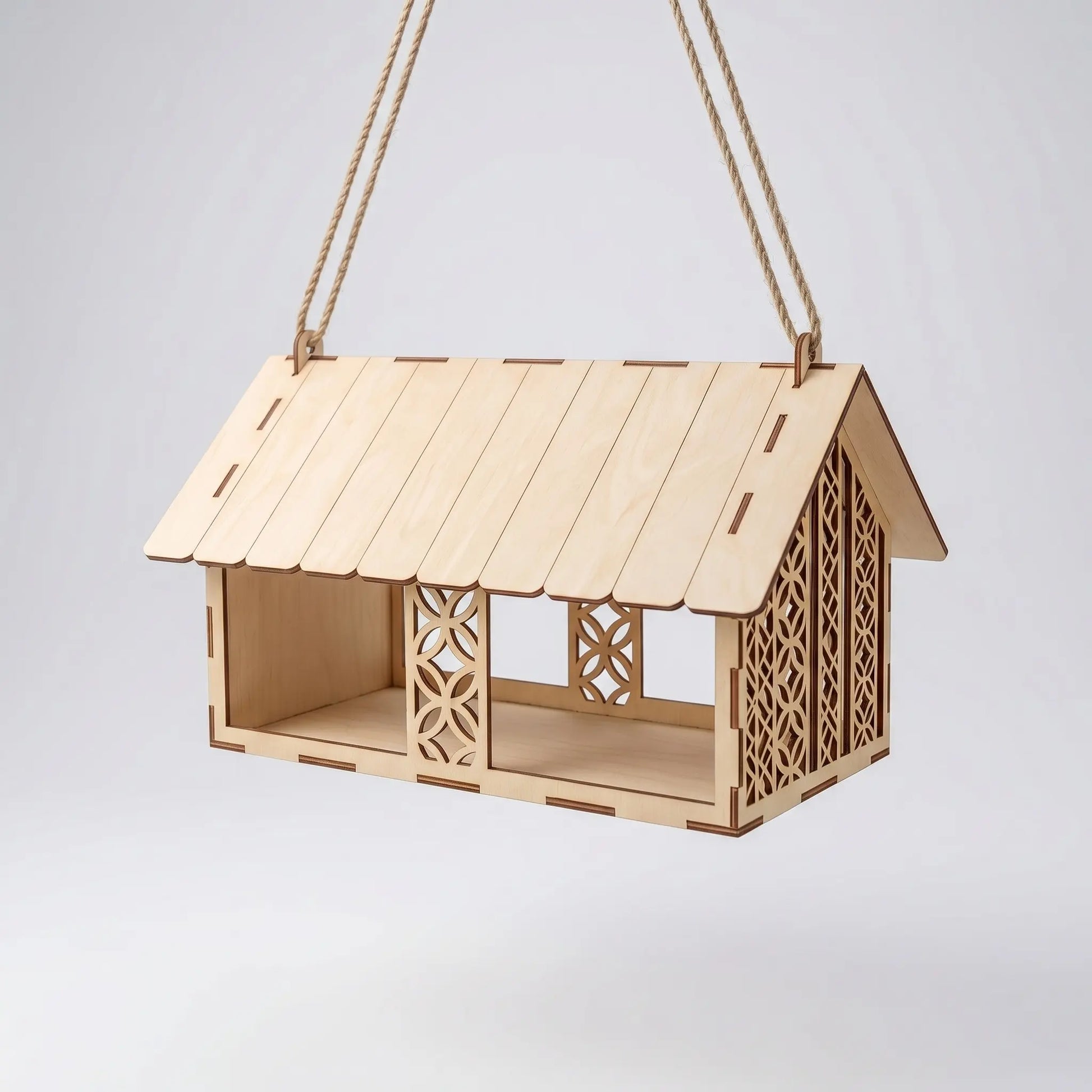 Wooden birdhouse with decorative cutouts on a white background