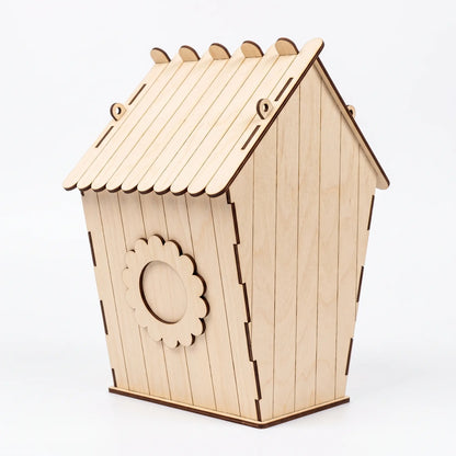 A wooden laser cut birdhouse with a slanted roof and a circular cutout on the side.