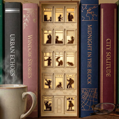 Detailed laser cut wooden Book Nook Apartment House with illuminated windows, nestled between books on a study shelf background.