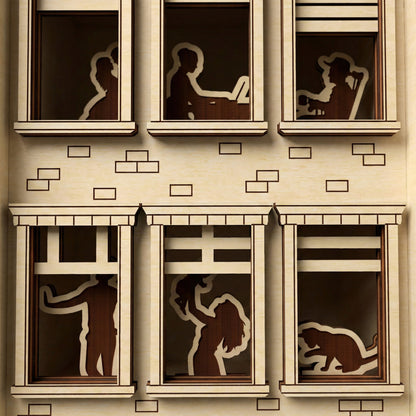 Macro view of a laser cut wooden Book Nook Apartment House highlighting intricate window silhouettes, with a close-up architectural facade background.