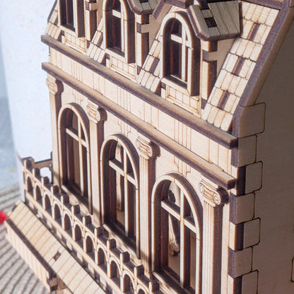 Macro close-up showing layered details, columns, and windows of an architectural miniature in laser cut plywood