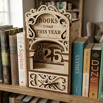 Decorative laser cut wooden bookshelf insert reading tracker with vintage scroll ornaments, number counter display, and book lover decor design placed between books.