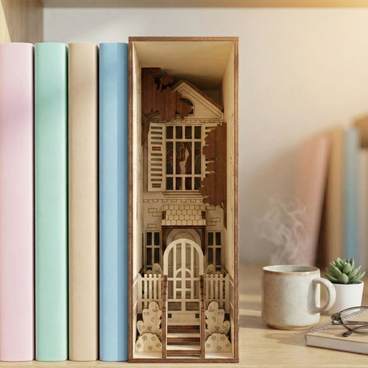A townhouse book nook made of laser cut plywood inserted between pastel-colored books. Shows intricate layers of a house exterior, including a fenced garden, steps, and window shutters in a bright room.