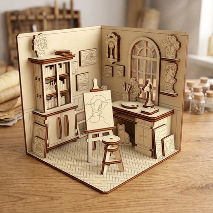 Assembled miniature art studio miniature crafted from laser cut plywood, shown inside a bright woodcraft workshop.