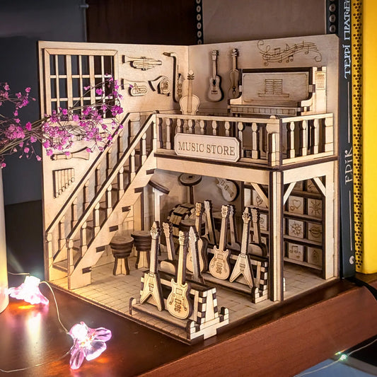 Assembled laser cut plywood music store shelf insert illuminated by warm flower shaped fairy lights on a wooden deck.