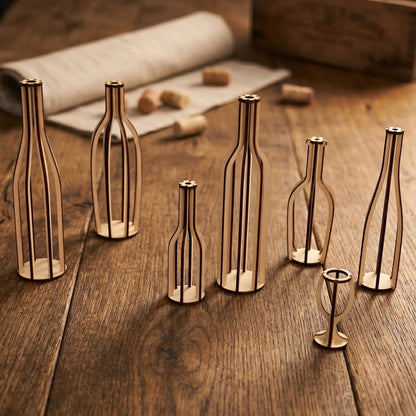 Skeletal laser cut plywood bottle silhouettes in various shapes on a rustic dark wood table with wine corks and a linen roll