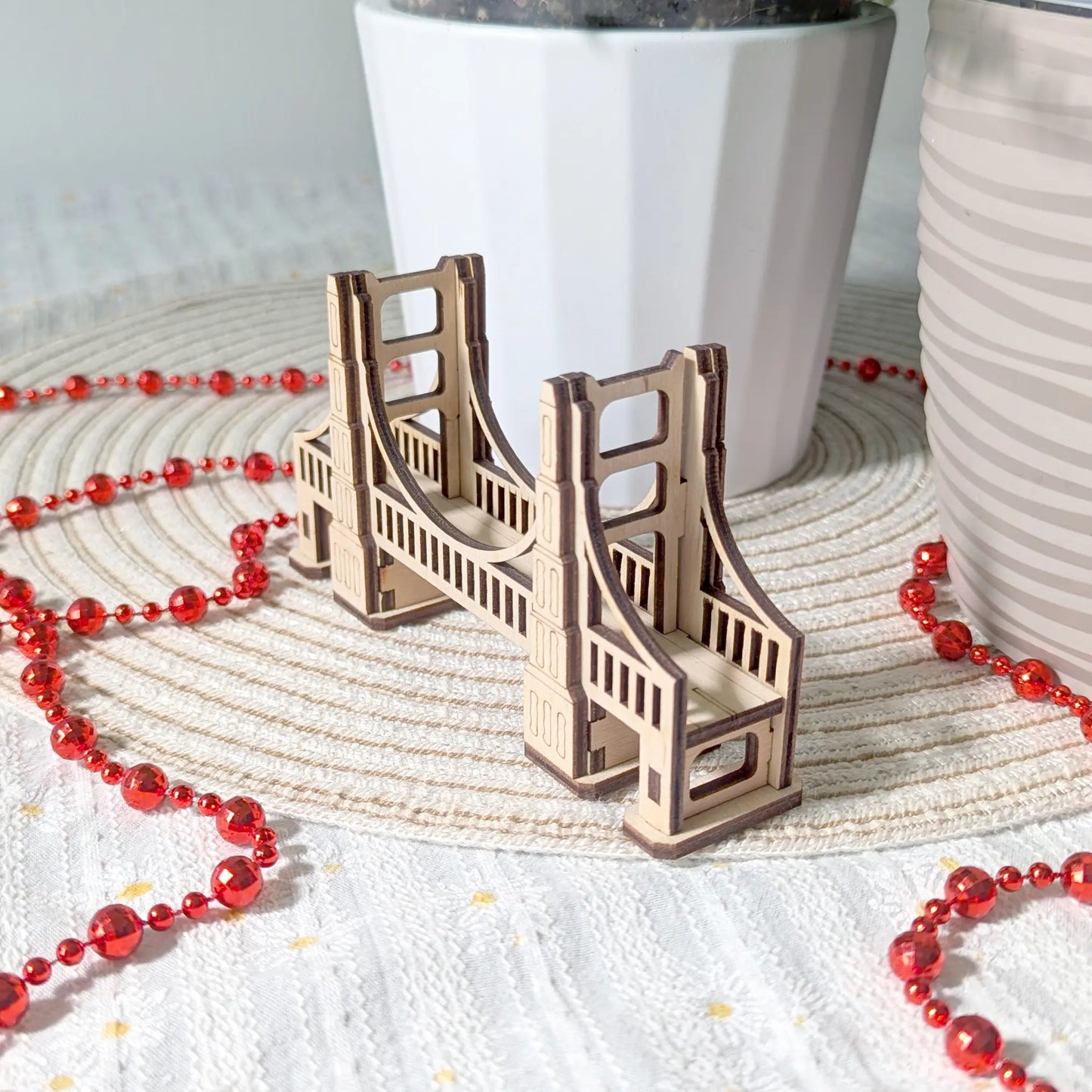 Side profile view of a miniature gaming bridge made of laser cut plywood, showcasing precise interlocking joints and slots